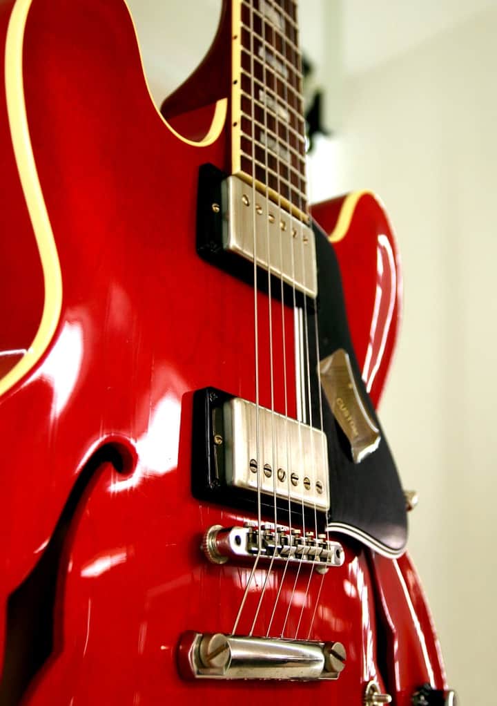 Una guitarra roja de cuerpo semihueco.